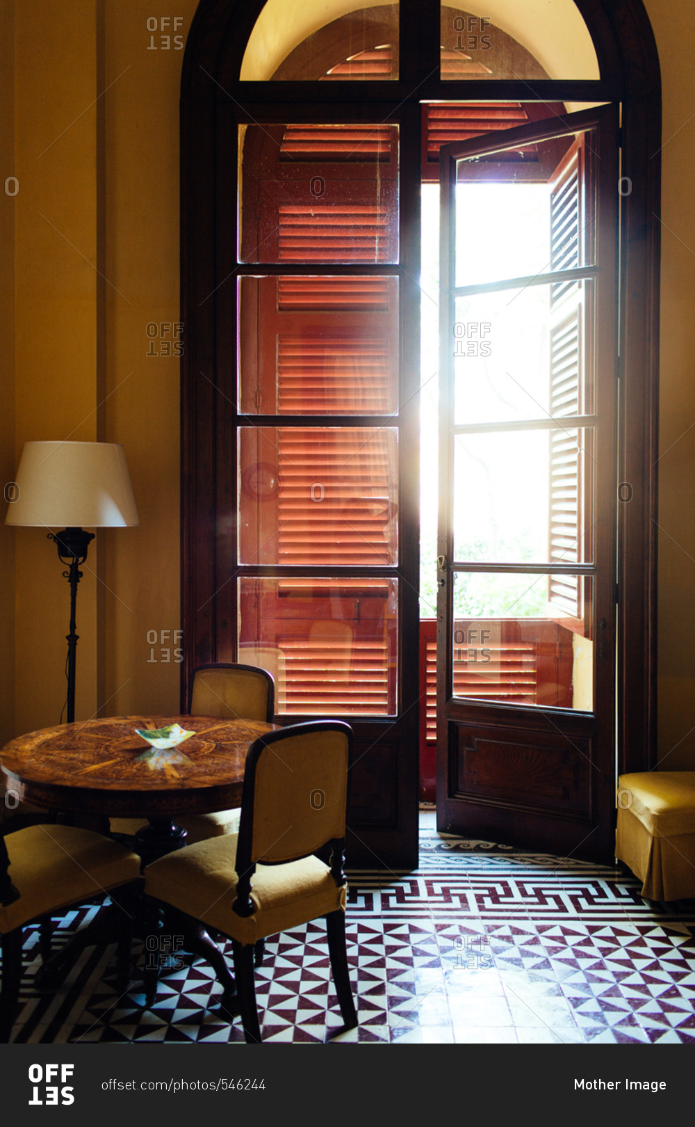 Sunlight shining through a window on a dining table and tile floor, Piano di Sorrento, Italy