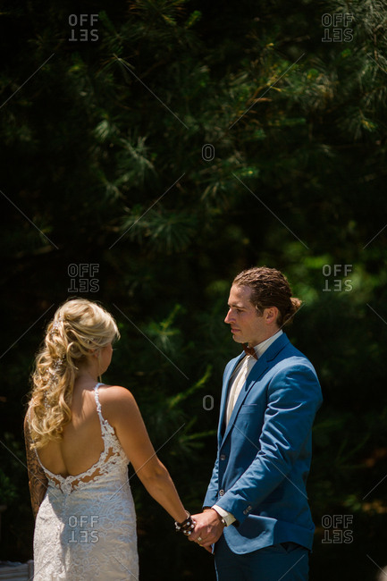 Emotional groom gazing at bride during ceremony