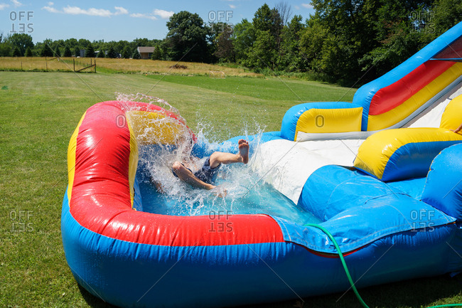 man playing on inflatable water slide