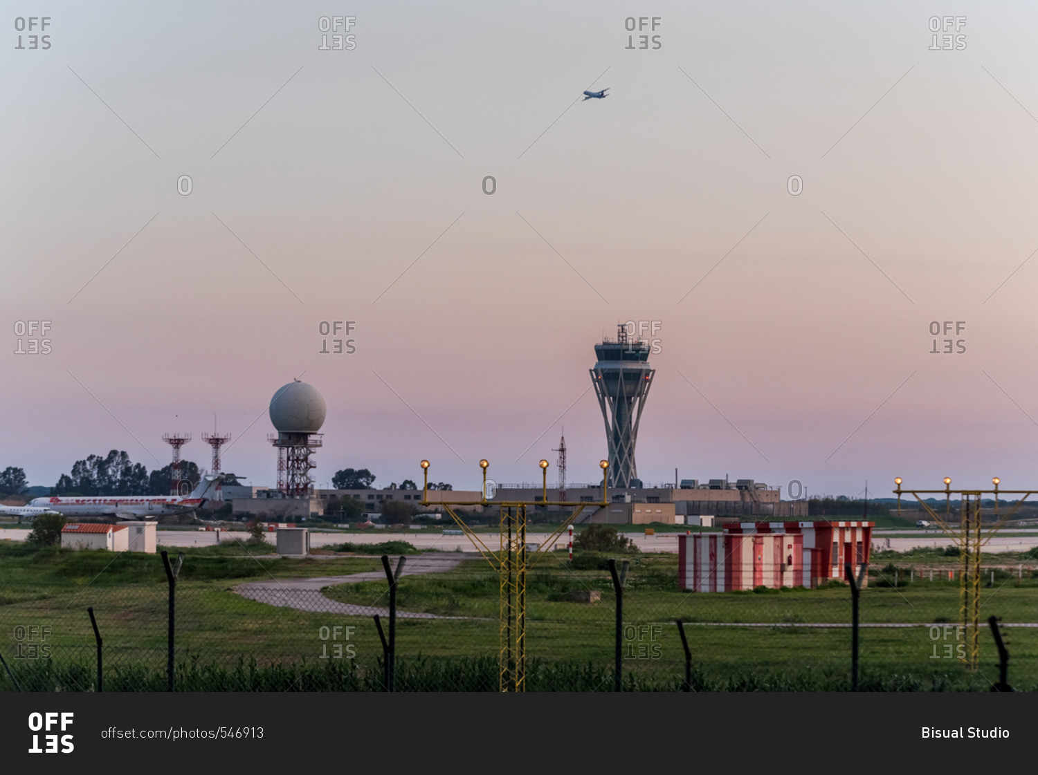 Industrial airfield and towers at sunset