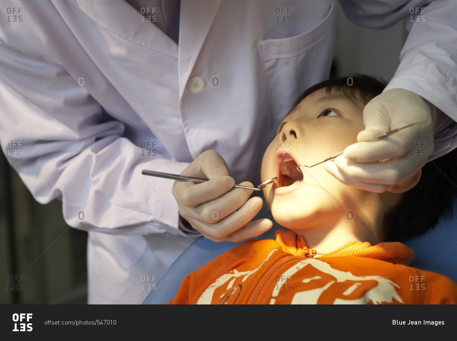 Dentist Examining Boy's Teeth