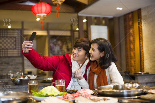 Young couple taking self portrait with a smart phone
