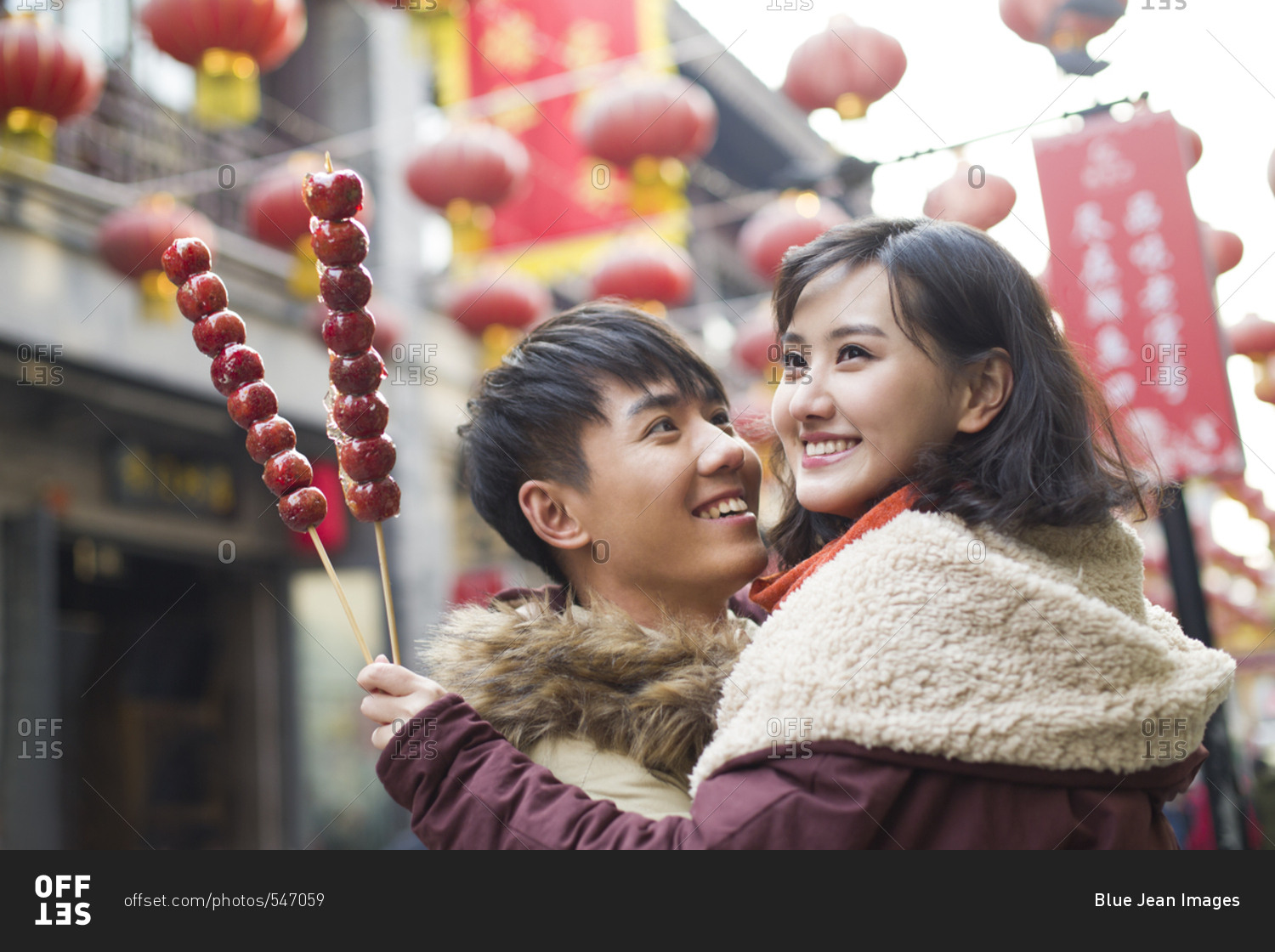 Young couple with candied haw berries celebrating Chinese New Year