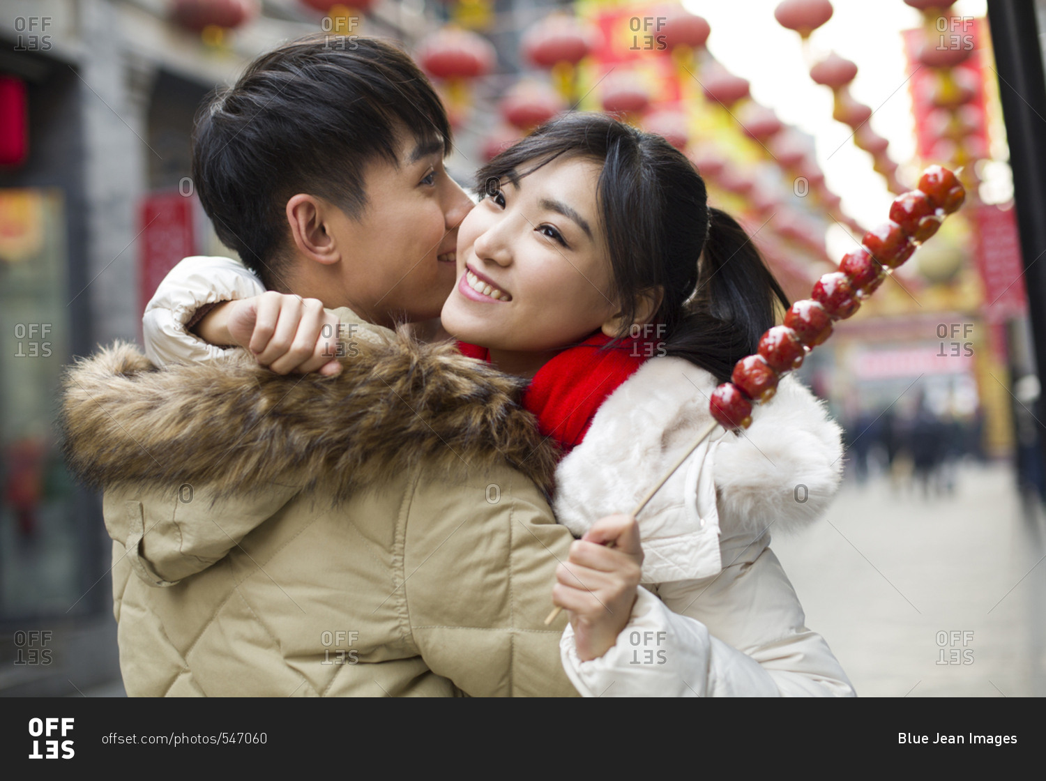 Young couple with candied haw berries celebrating Chinese New Year
