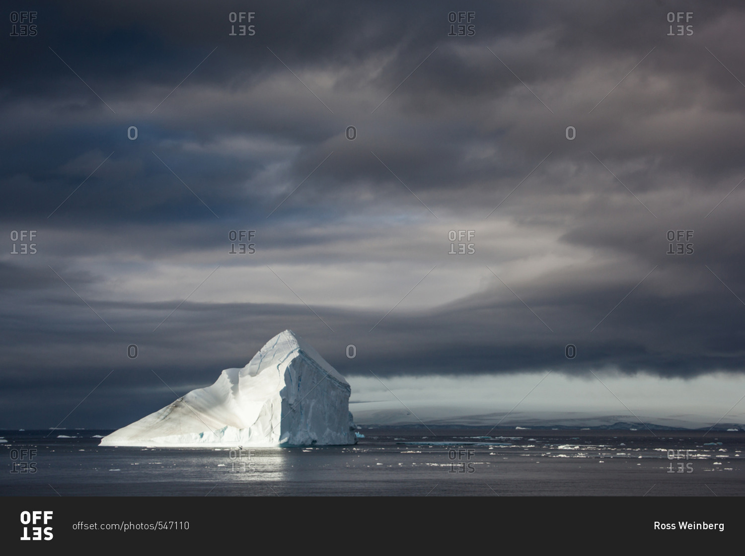 A half-lite Iceberg float on a calm day near the Antarctic Peninsula.
