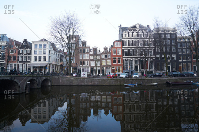 Amsterdam, Netherlands - January 18, 2017: Row houses along a canal in Amsterdam