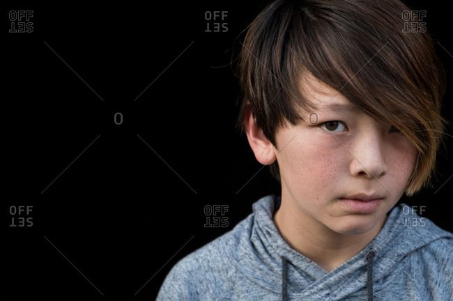 Close up of a boy with brown hair and freckles stock photo - OFFSET