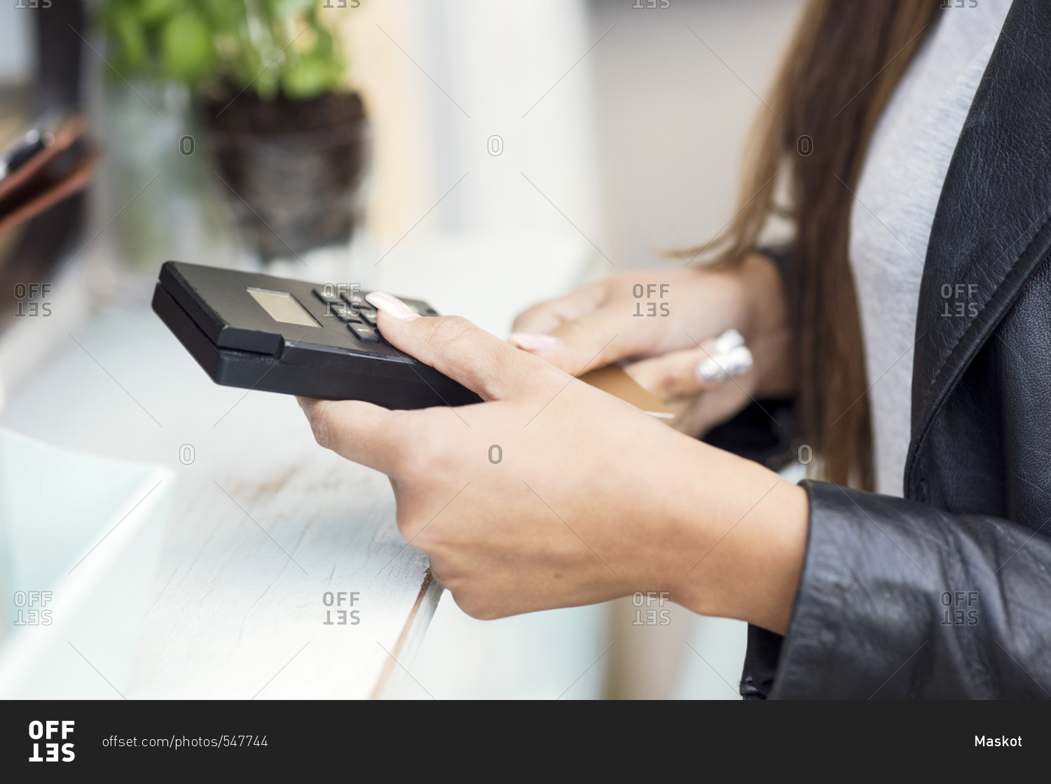 Midsection of female customer paying through credit card at food truck
