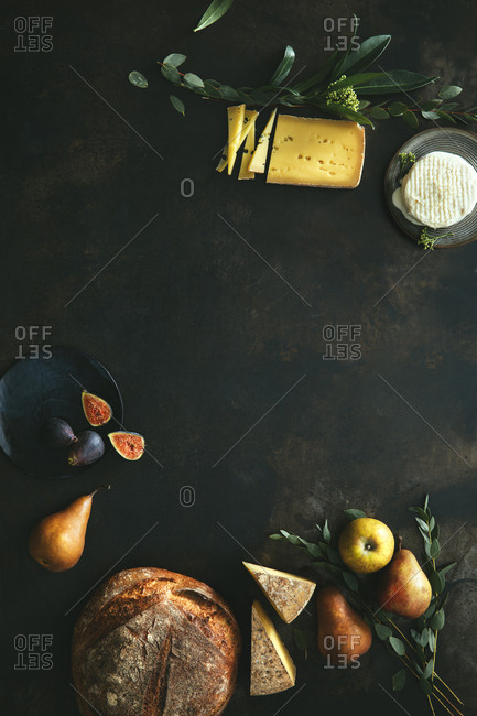 Still life scene with bread, fruits, and cheese