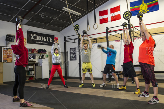 Passy, RA, France - December 8, 2015: Coaching demonstrating kettle bell movements during a training