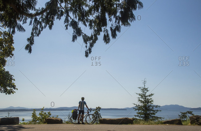 Bellingham, Washington, USA - July 2, 2014: The famous Chuckanut Drive near Bellingham, Washington attracts bikers and drivers who enjoy the original scenic drive in Washington as it hugs the coastline and winds through thick forests with a deep green canopy.