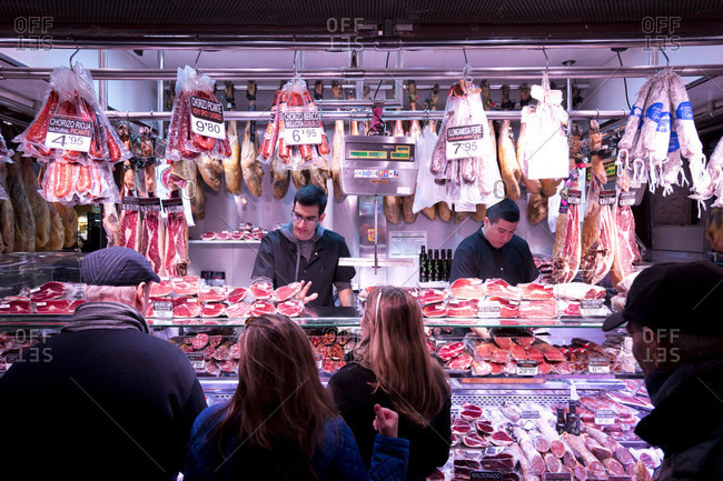 Barcelona, Barcelona, Spain - November 24, 2015: People shopping at a butcher shop in Barcelona, Spain.