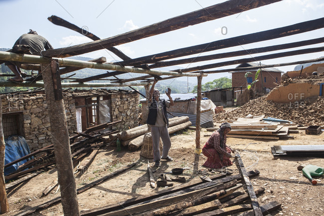 Lele Village, Bagmati, Nepal - May 4, 2015: Houses have fallen down but people are standing tall. Tamang Community of Lele Village helping one another rebuilding houses and restoring lives they lost to cruel earthquake
