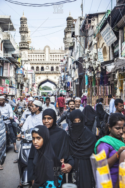 Hyderabad, South India, India - October 18, 2015: Burkha women walk pass busy streets and market near Char Minar in Hyderabad, India,