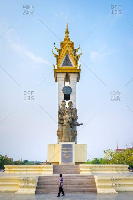 Phnom Penh, Phnom Penh, Cambodia - April 5, 2015: A man walks past the Cambodia-Vietnam Friendship Monument, Phnom Penh, Cambodia
