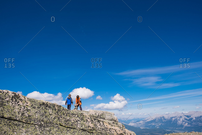 Two boys on mountain peak