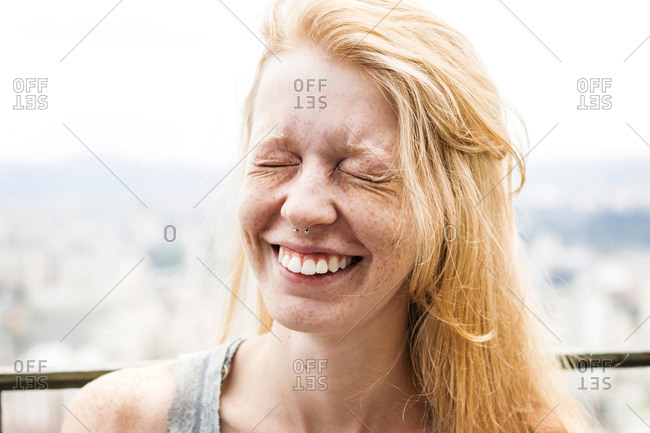 Grinning young woman with freckles