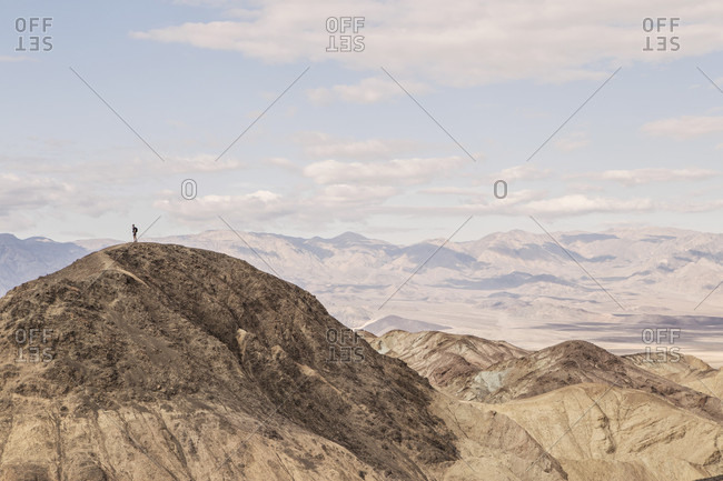 A Hiker Standing On Peak Desolation Canyon Trail In California's Death Valley National Park