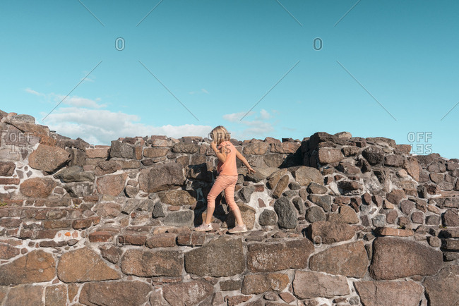 Girl plays in ruins