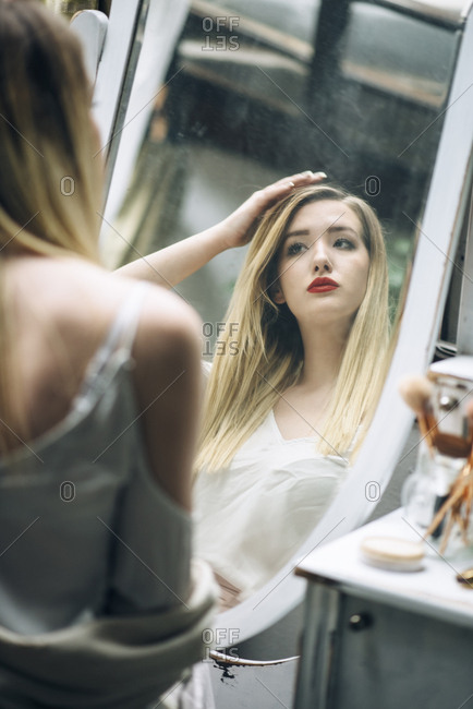 Sexy girl in white lace underwear lying on the bed, looking sad and alone  Stock Photo