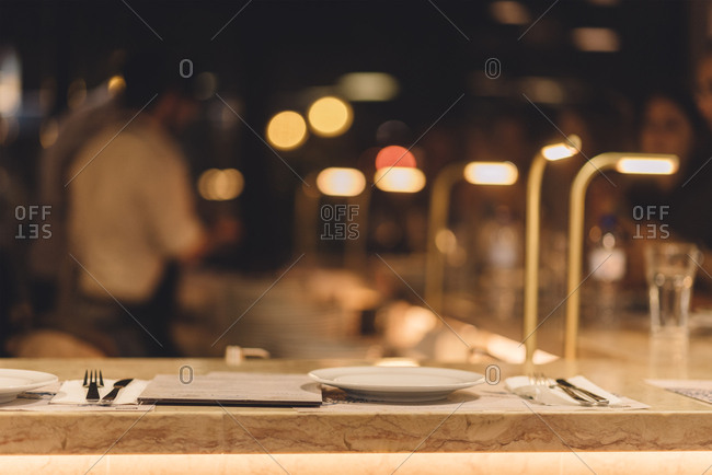 Food restaurant bar at evening with blurred people in background. stock  photo - OFFSET