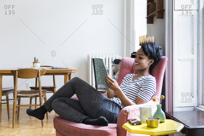 black woman reading magazine
