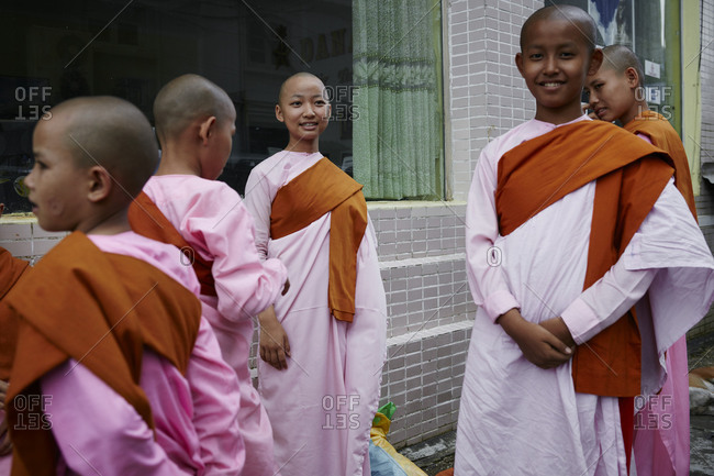 Yangon, Myanmar - August 7, 2015: Young monks in downtown Yangon, Myanmar