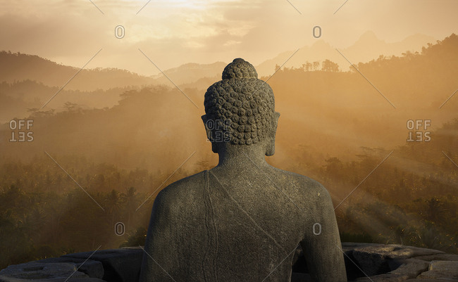 Statue of Buddha at sunset, Borobudur, Java, Indonesia
