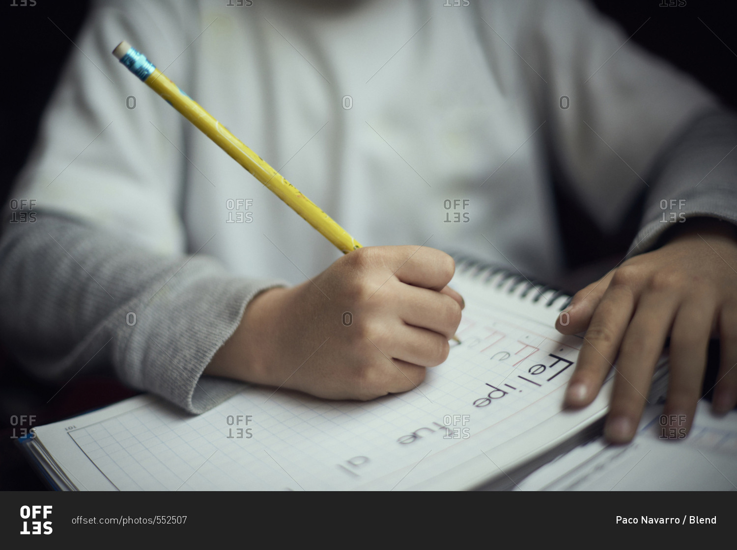 Hispanic boy practicing writing alphabet