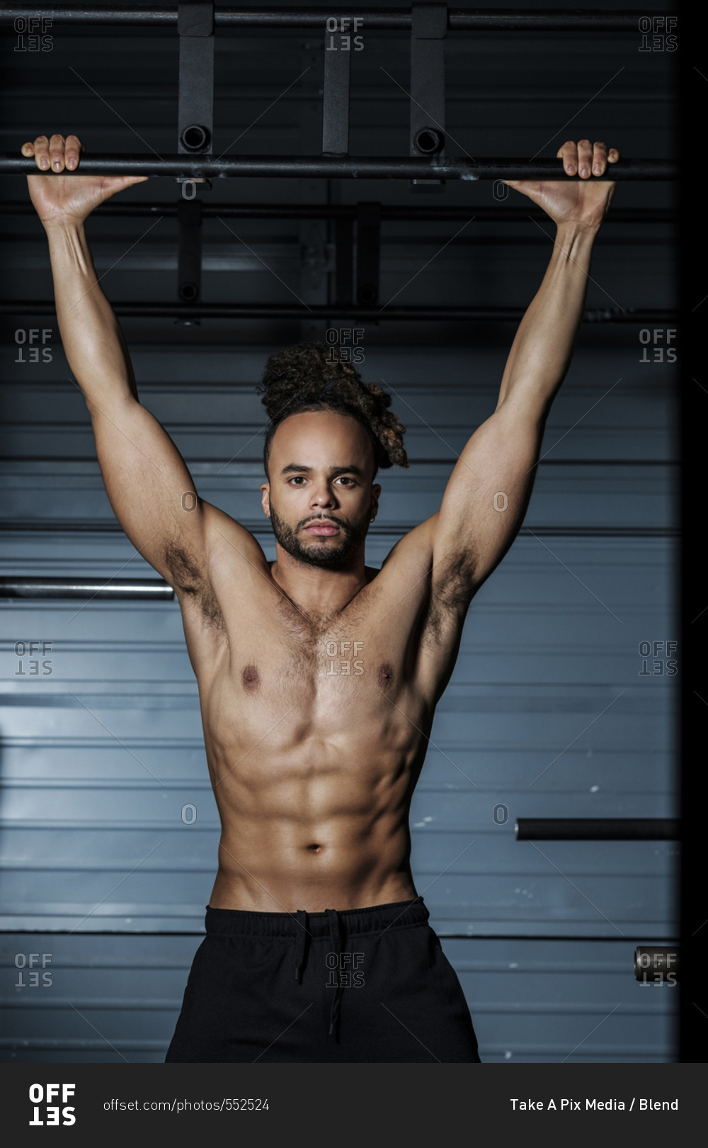 Mixed Race Man Holding Bar In Gymnasium Stock Photo Offset