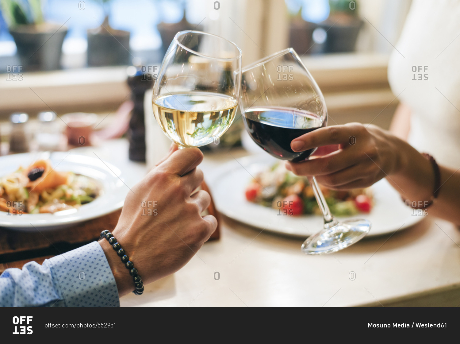 Couple toasting with wine- close-up