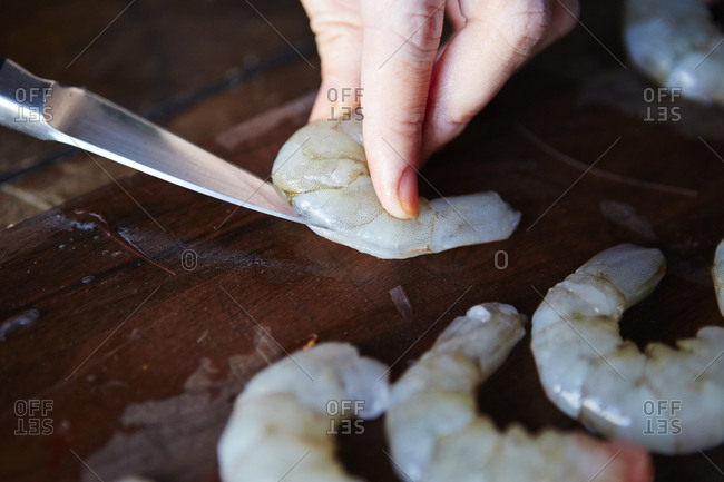 Person cleaning shrimp - Offset Collection