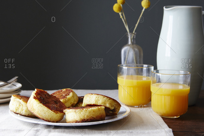 Plate of orange-fig-ricotta pancakes with orange juice