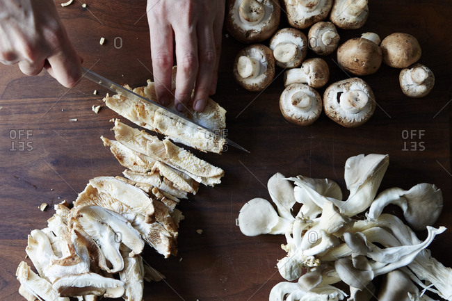 Person slicing fresh mushrooms - Offset