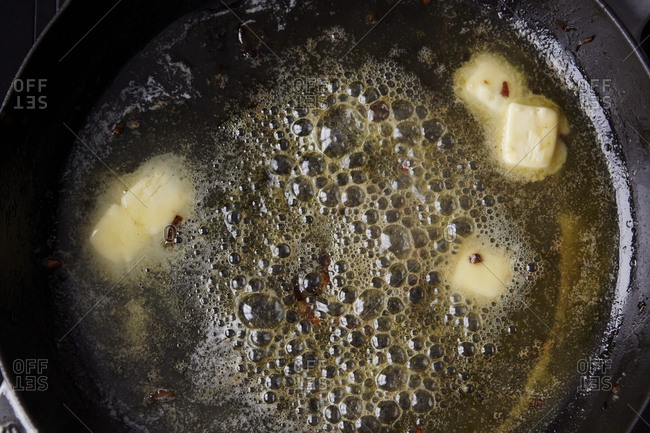 Sizzling melted butter in skillet