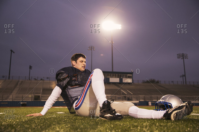 American football players walking on field stock photo - OFFSET