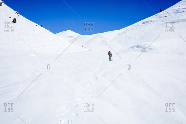 Mid distance view of hiker hiking on snow covered mountain at Joshua Tree National Park