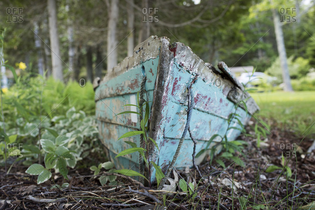 Weathered wooden boat on dry ground in Cushing, Maine