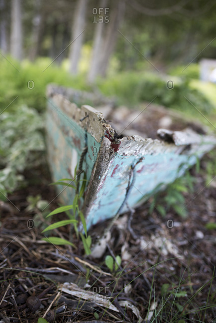 Bow of weathered wooden boat on dry ground in Cushing, Maine