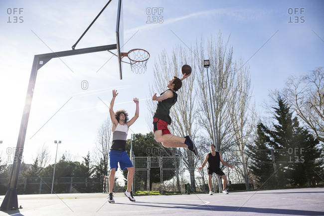 Basketball player making slam dunk