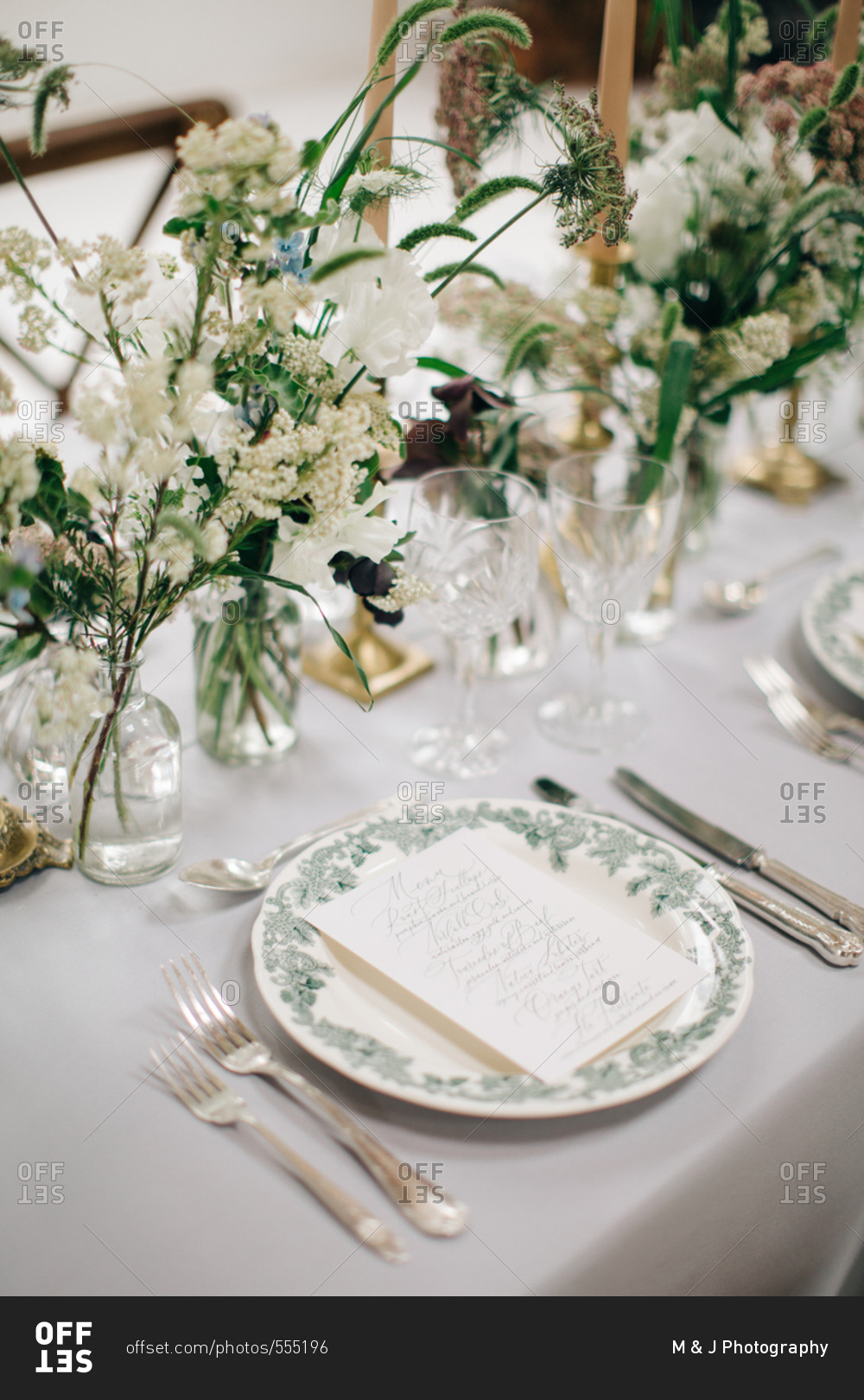 Printed menu card on table set with white wildflowers