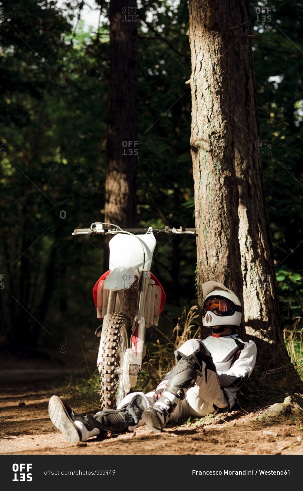 Italy- Motocross biker taking a break in Tuscan forest