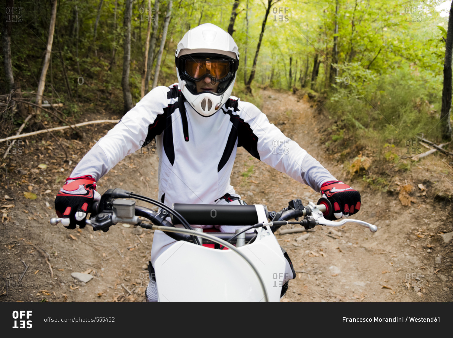 Italy- Motocross biker ridding in Tuscan forest