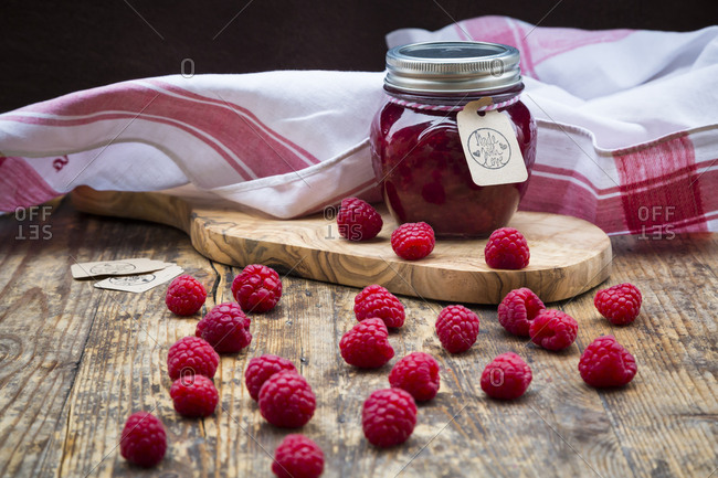 Jar of raspberry jam and raspberries