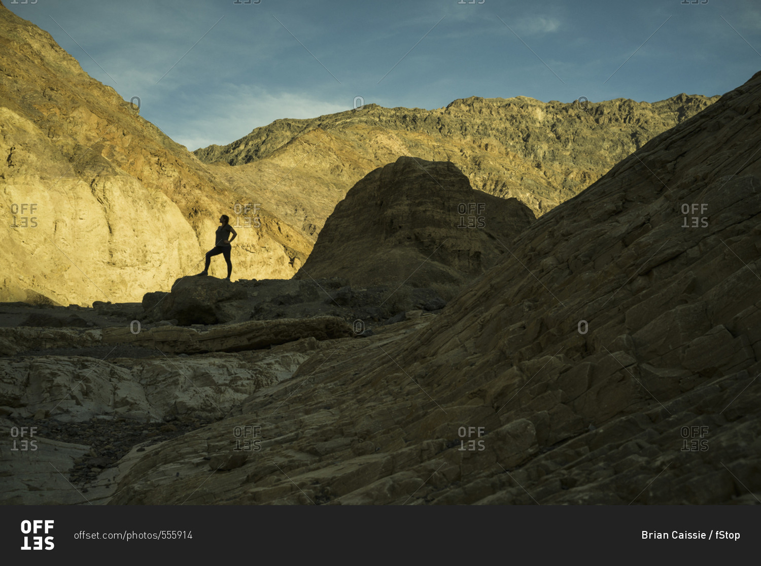 Silhouette of woman standing in rocky landscape, Death Valley, Nevada, USA