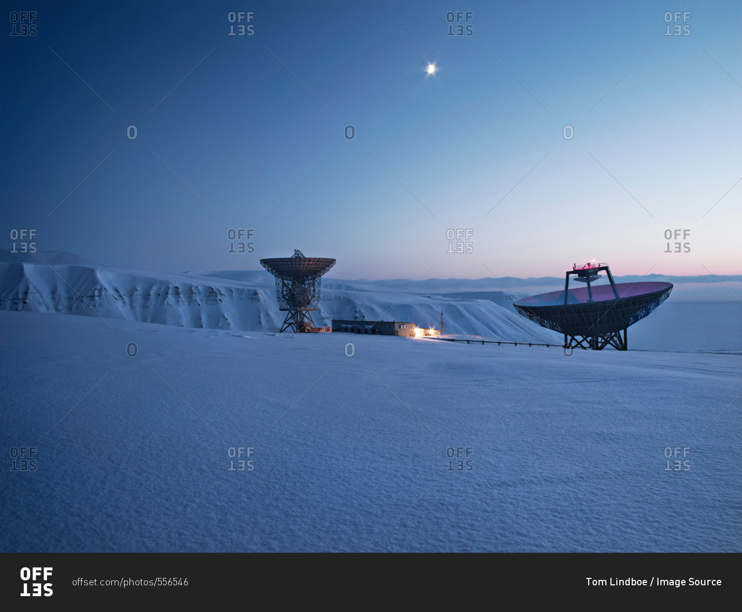 Satellite dishes in snowy landscape