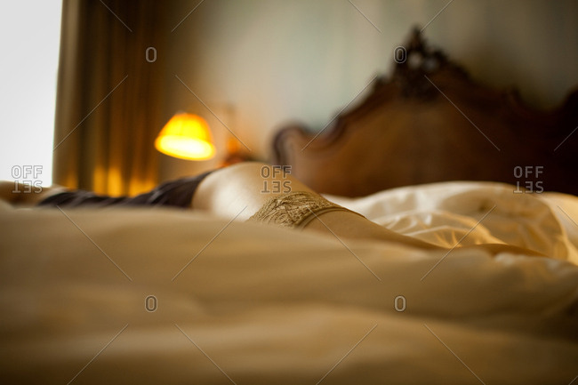 Woman lying on bed wearing underwear