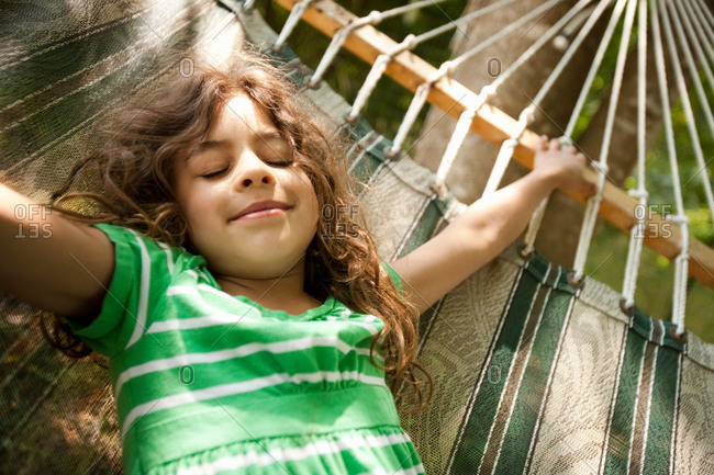 Young girl lying on hammock