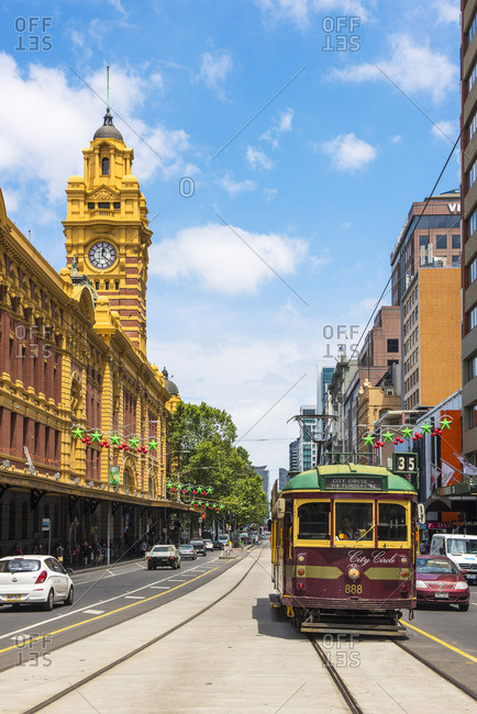 Melbourne, Australia - December 6, 2016: Melbourne, Victoria, Australia.  Flinders Street Station and the historical old tram. stock photo - OFFSET