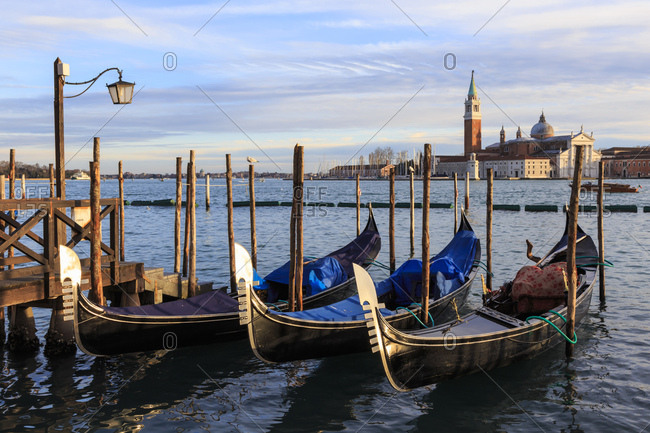 Gondolas, San Marco waterfront at sunset in winter, view to San Giorgio Maggiore, Venice, UNESCO World Heritage Site, Veneto, Italy, Europe